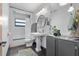 Bathroom with a pedestal sink, modern fixtures, a tiled shower, and neutral gray and white finishes at 808 Denton Rd, Winter Park, FL 32792