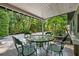 A charming covered patio is ideal for outdoor dining and entertaining with backyard views at 808 Denton Rd, Winter Park, FL 32792