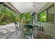 Relax and dine on this covered patio overlooking the beautifully landscaped backyard at 808 Denton Rd, Winter Park, FL 32792