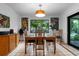 Dining room includes decorative paintings, a wood table, and views of the outdoors at 808 Denton Rd, Winter Park, FL 32792