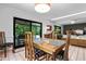Dining room with a table set for four, sliding glass doors to the backyard, and a view into the living room at 808 Denton Rd, Winter Park, FL 32792