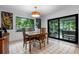 Dining room featuring a wood table, stylish light fixture, and a view of the outdoor patio at 808 Denton Rd, Winter Park, FL 32792