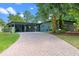 Charming home featuring a brick driveway, lovely yard, and inviting facade with a carport at 808 Denton Rd, Winter Park, FL 32792