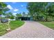 Charming home featuring a brick driveway, lovely yard, and inviting facade with a carport at 808 Denton Rd, Winter Park, FL 32792