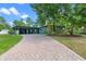 Charming home featuring a brick driveway, lovely yard, and inviting facade with a carport at 808 Denton Rd, Winter Park, FL 32792