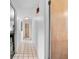 Hallway featuring neutral walls, tile flooring, and doors leading to various rooms in the home at 808 Denton Rd, Winter Park, FL 32792