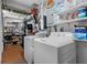 Fully equipped laundry room with a washer, dryer and ample shelving for storage and organization at 808 Denton Rd, Winter Park, FL 32792
