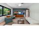 Living room featuring an entertainment center, plush seating, and a large window with views of lush greenery at 808 Denton Rd, Winter Park, FL 32792