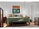 Bright main bedroom featuring neutral tones, a decorative bench and a window with natural light at 808 Denton Rd, Winter Park, FL 32792
