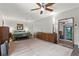 Spacious main bedroom with natural light, ceiling fan, and view of a large mirror at 808 Denton Rd, Winter Park, FL 32792