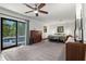 Spacious main bedroom with natural light, ceiling fan, and sliding doors leading to the pool area at 808 Denton Rd, Winter Park, FL 32792