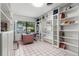 A bright office includes built-in shelving and a large window offering an abundance of light at 808 Denton Rd, Winter Park, FL 32792