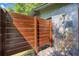 This private outdoor shower is surrounded by a wooden screen and stone accents at 808 Denton Rd, Winter Park, FL 32792
