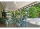 Inviting covered patio with seating, ceiling fans, and tile flooring overlooking a lush backyard at 808 Denton Rd, Winter Park, FL 32792