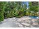 A serene pool area featuring lush landscaping providing privacy and a tranquil setting at 808 Denton Rd, Winter Park, FL 32792