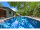 A sparkling blue pool offers a refreshing retreat in the lush backyard at 808 Denton Rd, Winter Park, FL 32792