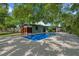 An inviting backyard pool is surrounded by lush landscaping and a privacy fence at 808 Denton Rd, Winter Park, FL 32792