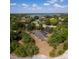 Aerial view of property surrounded by lush greenery, homes and a lake nearby at 8735 Rancho Ct, Orlando, FL 32836