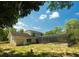 Exterior of home showcasing backyard, screened pool and mature trees at 8735 Rancho Ct, Orlando, FL 32836