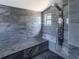 Modern bathroom showcasing a marble-tiled shower with a built-in bench and rainfall shower head at 8735 Rancho Ct, Orlando, FL 32836