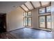 Spacious living room with a high ceiling, wooden beams, large windows, and hardwood flooring at 8735 Rancho Ct, Orlando, FL 32836