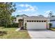 Charming single-story home with a two-car garage and a well-maintained lawn at 11460 Brown Quail Ct, Orlando, FL 32817