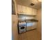 A kitchen area with white cabinets, appliances, and a tile floor at 128 Water Front Way # 300, Altamonte Springs, FL 32701