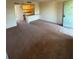 A carpeted living room leads to an open kitchen area with an entrance at 128 Water Front Way # 300, Altamonte Springs, FL 32701