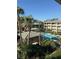 Community pool area surrounded by lush tropical landscaping at 128 Water Front Way # 300, Altamonte Springs, FL 32701