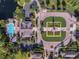 Aerial view highlighting the community pool, clubhouse, and manicured landscaping; enjoy community living at 15160 Avenue Of The Arbors, Winter Garden, FL 34787