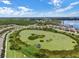 Aerial view showcasing community, lake, and lush landscaping, highlighting the community's natural beauty and amenities at 15160 Avenue Of The Arbors, Winter Garden, FL 34787