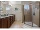 Bathroom features a dual vanity with granite counters, updated fixtures, and a glass enclosed shower at 15160 Avenue Of The Arbors, Winter Garden, FL 34787