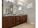 Updated bathroom features a dual vanity with granite counters and updated fixtures at 15160 Avenue Of The Arbors, Winter Garden, FL 34787