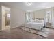 Spacious bedroom with neutral tones, ensuite bathroom access, plush carpet, and a decorative rug at 15160 Avenue Of The Arbors, Winter Garden, FL 34787