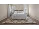 Bright bedroom features a decorative rug, two side tables with lamps, and neutral decor at 15160 Avenue Of The Arbors, Winter Garden, FL 34787