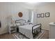 Decorated bedroom featuring a patterned accent wall, desk, and a black metal bed frame at 15160 Avenue Of The Arbors, Winter Garden, FL 34787