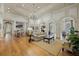 Spacious clubhouse featuring elegant chandeliers, comfortable seating, and stylish decor with hardwood flooring throughout at 15160 Avenue Of The Arbors, Winter Garden, FL 34787