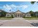 Inviting clubhouse featuring classic architecture and a welcoming American flag, creating a strong community presence at 15160 Avenue Of The Arbors, Winter Garden, FL 34787