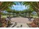 Inviting common area surrounded by lush trees, offering benches and serene views for relaxation and community gatherings at 15160 Avenue Of The Arbors, Winter Garden, FL 34787