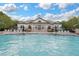 Beautiful pool area with lounge chairs and umbrellas, ideal for enjoying sunny days in a relaxed setting at 15160 Avenue Of The Arbors, Winter Garden, FL 34787