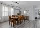Bright dining room featuring hardwood floors and a modern light fixture at 15160 Avenue Of The Arbors, Winter Garden, FL 34787