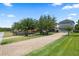 Long brick driveway leading to the attached garage. Mature trees add to the curb appeal at 15160 Avenue Of The Arbors, Winter Garden, FL 34787