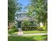 Charming two-story home featuring a well-manicured lawn and lush landscaping at 15160 Avenue Of The Arbors, Winter Garden, FL 34787