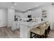 Open kitchen boasts white cabinets, stainless steel appliances, island seating, and quartz countertops at 15160 Avenue Of The Arbors, Winter Garden, FL 34787