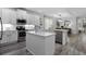 Beautiful kitchen with white cabinets, quartz countertops, stainless steel appliances, and a large central island at 15160 Avenue Of The Arbors, Winter Garden, FL 34787