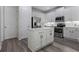 Charming kitchen showcases white cabinets, stainless steel appliances, a central island, and ample counter space at 15160 Avenue Of The Arbors, Winter Garden, FL 34787