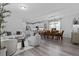 Open-concept living space with modern decor, connecting living room, dining, and kitchen at 15160 Avenue Of The Arbors, Winter Garden, FL 34787
