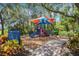 Colorful playground with slides, climbing structures, and soft ground cover, set in a scenic park environment at 15160 Avenue Of The Arbors, Winter Garden, FL 34787
