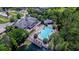 Overhead picture of a community pool area complete with lounge chairs, cabana, and nearby lake access at 15160 Avenue Of The Arbors, Winter Garden, FL 34787