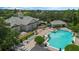 Aerial view of the community clubhouse featuring a sparkling pool, lounge chairs, and landscaped surroundings at 15160 Avenue Of The Arbors, Winter Garden, FL 34787